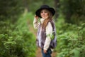 Spring portrait of a little girl.Sweet girl with big brown eyes in a black hat and a fur vest. Royalty Free Stock Photo