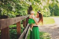 Spring portrait of mother and baby daughter playing outdoor in matching outfit - long skirts and shirts Royalty Free Stock Photo