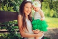 Spring portrait of mother and baby daughter playing outdoor in matching outfit - long skirts and shirts Royalty Free Stock Photo