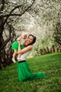 Spring portrait of mother and baby daughter playing outdoor in matching outfit - long skirts and shirts Royalty Free Stock Photo