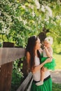 Spring portrait of mother and baby daughter playing outdoor in matching outfit - long skirts and shirts Royalty Free Stock Photo