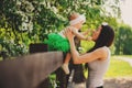 Spring portrait of mother and baby daughter playing outdoor in matching outfit - long skirts and shirts