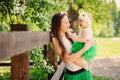 Spring portrait of mother and baby daughter playing outdoor in matching outfit - long skirts and shirts Royalty Free Stock Photo