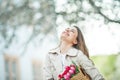 Spring portrait of a young beautiful happy woman 28 years old with long well-groomed hair holds a wicker bag in her hands with a Royalty Free Stock Photo