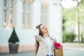 Spring portrait of a young beautiful happy woman 28 years old with long well-groomed hair holds a wicker bag in her hands with a Royalty Free Stock Photo