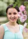 Spring positive cheerful young female portrait in garden