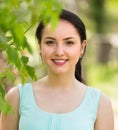 Spring positive smiling young female portrait in garden