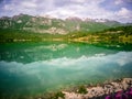 Spring reflections of the Mainarde mountains in the lake of Castel San Vincenzo Royalty Free Stock Photo