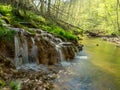 Spring river waterfall,  stones, green moss and spring trees, David`s sources, Latvia Royalty Free Stock Photo