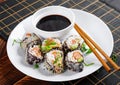 Spring roll with nori, sushi rice, salmon, cucumber and avocado, sriracha Royalty Free Stock Photo