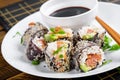 Spring roll with nori, sushi rice, salmon, cucumber and avocado, sriracha Royalty Free Stock Photo
