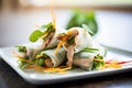 spring rolls with lemongrass chicken slices, fresh herbs on top