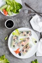 Spring rolls in rice paper made from shrimp, olives, lettuce and vegetables on a plate. Top view Royalty Free Stock Photo