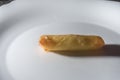 spring rolls on a white brato with hands opening a cheese roll