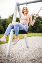 Spring romantic woman swinging on swing