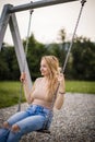 Spring romantic woman swinging on swing