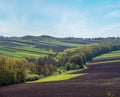 Spring rural landscape with fields, farmlands, village outskirts, flowering trees, hilly meadows. Chernivtsi region, Ukraine Royalty Free Stock Photo