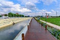 Boardwalk on the dam by the fields. Royalty Free Stock Photo