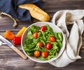 Spring salad with fresh green rocket, spinach leaves and cherry Royalty Free Stock Photo