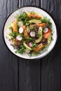 Spring salad of salmon, avocado, radish and mix microgreen close-up on a plate. Vertical top view