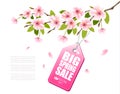 Spring sale background with a pink blooming sakura and discount tag.