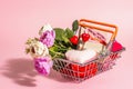 Spring Sale concept isolated on pink background. Shopping basket with festive gifts Royalty Free Stock Photo