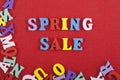 Spring sale word on red background composed from colorful abc alphabet block wooden letters, copy space for ad text. Learning Royalty Free Stock Photo