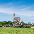 Spring scenery with rural Catholic church and small Bavarian village