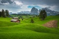 Spring scenery with snowy mountains and green fields, Dolomites, Italy