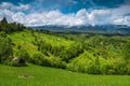 Spring scenery with snowy mountains and green hills, Transylvania, Romania Royalty Free Stock Photo