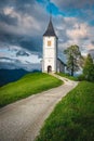 Rural road and Saint Primoz church on the hill, Slovenia Royalty Free Stock Photo