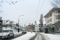 A snow track on the street along the houses.