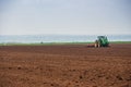 Spring sowing. Tractors loose arable land.