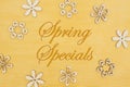 Spring Specials message with wood flower petals on hand painted distressed gold