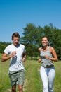 Spring - Sportive couple jogging in the meadow