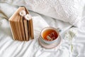 Spring still life with a Cup of Natural herbal tea and flowers camomile and daisy . Light background, blooming and cozy house. Royalty Free Stock Photo