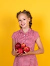 Spring style. happy girl holding apples from garden. kid hold fresh fruit. child eating red apple. summer healthy food Royalty Free Stock Photo