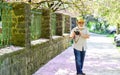 Spring style. tourism and holiday. traveler camera man under sakura bloom garden. travel concept. male photographer