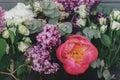 Spring stylish bouquet composition on rustic wood, still life. Peony, lilac, eucalyptus, roses