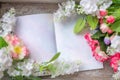 Spring and summer background.Flowers on a wooden texture with a Notepad for notes. Space for text Royalty Free Stock Photo