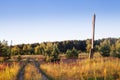 Rural road in green grass field meadow scenery lanscape with blue sky Royalty Free Stock Photo