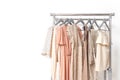 Elegant dress, jumper, trousers and other fashion outfit pastel beige color. Spring cleaning home wardrobe. Copy space