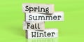 Spring, summer, fall, winter - words on wooden blocks