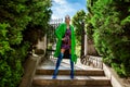 Spring, summer fashion. High fashion model. Glamour, stylish elegant woman. Female model in colorful dress and Trendy green  coat Royalty Free Stock Photo