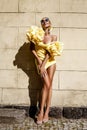 Spring, summer fashion. High fashion model. Glamour, stylish elegant woman. Female model in amazing yellow dress in the city. Royalty Free Stock Photo
