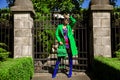 Spring, summer fashion. High fashion model. Glamour, stylish elegant woman. Female model in colorful dress and Trendy green  coat Royalty Free Stock Photo