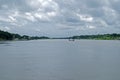 Spring summer landscape blue sky clouds Narew river boat green trees countryside Royalty Free Stock Photo