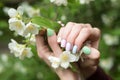 Spring summer manicure gel Polish. Delicate female hands with Jasmine flowers