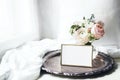 Spring, summer still life. Blank golden photo frame mockup on old silver tray near window. Vintage feminine styled photo Royalty Free Stock Photo