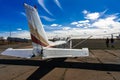 Spring sunny day, plane under blue sky with white clouds Royalty Free Stock Photo